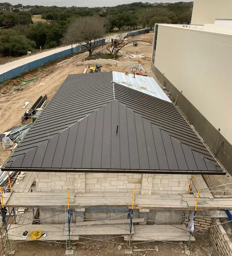 Metal roof new construction with scaffolding in Pine