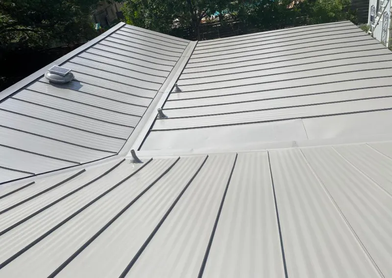 Solar attic fan installed on a metal roof for Roof Ventilation in Pine